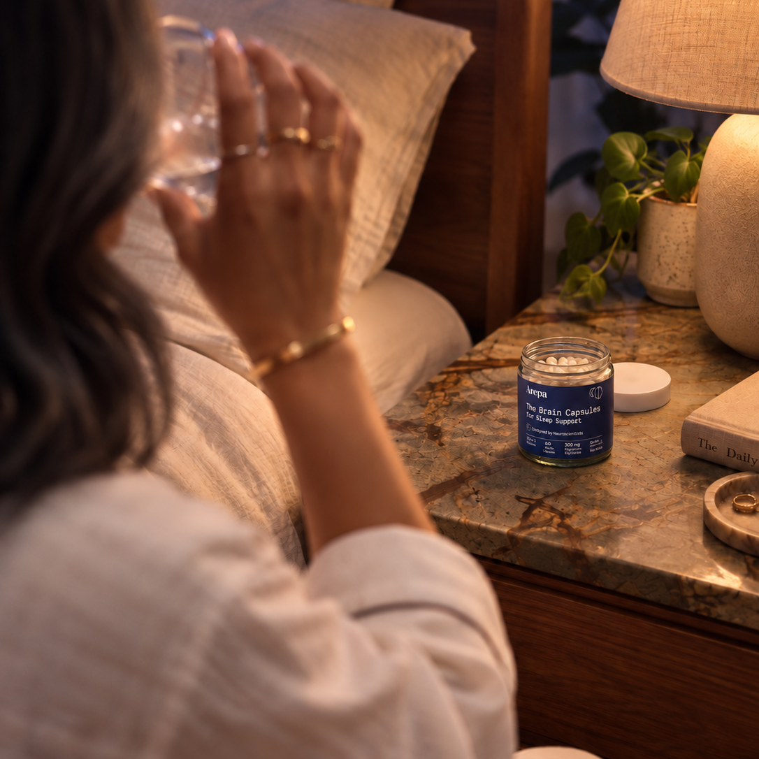 The Brain Capsules for Sleep Support - taking a capsule with water at bedtime